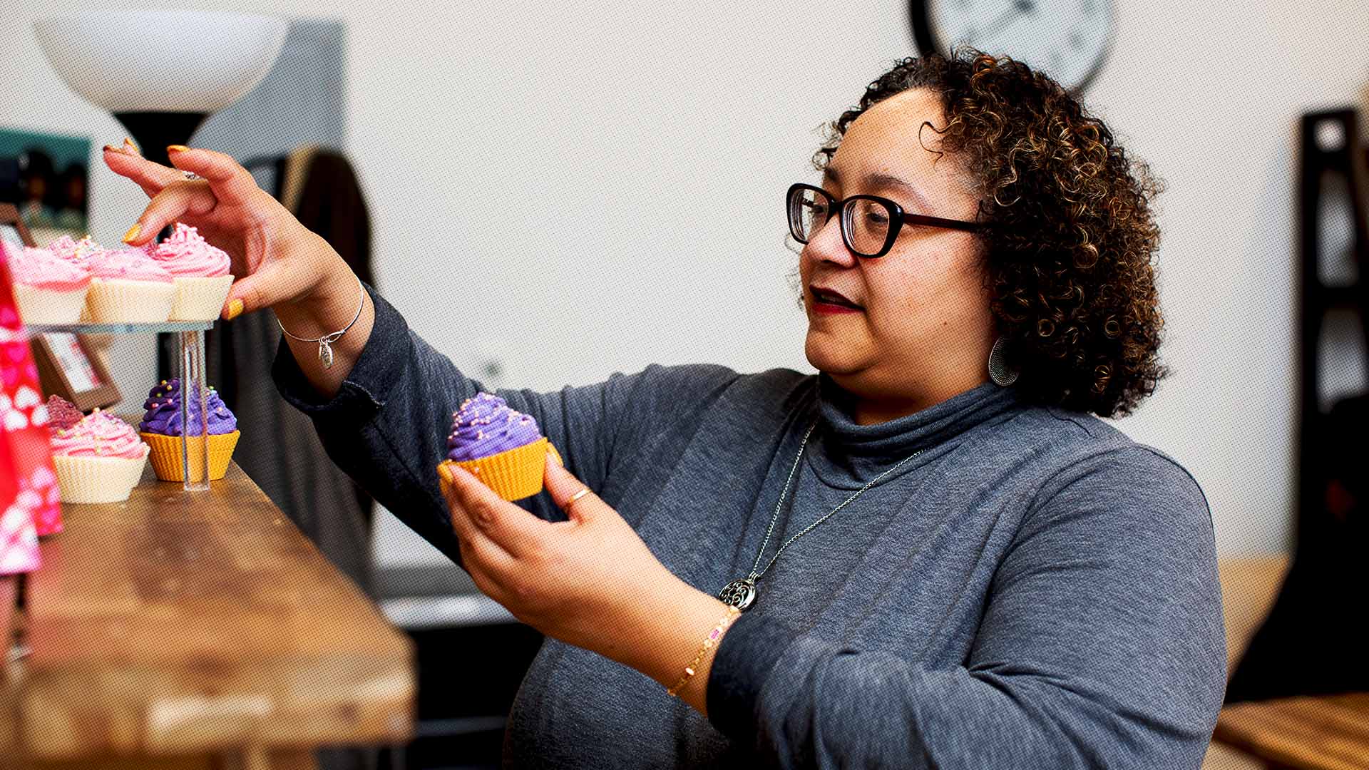 woman arranging cupcakes