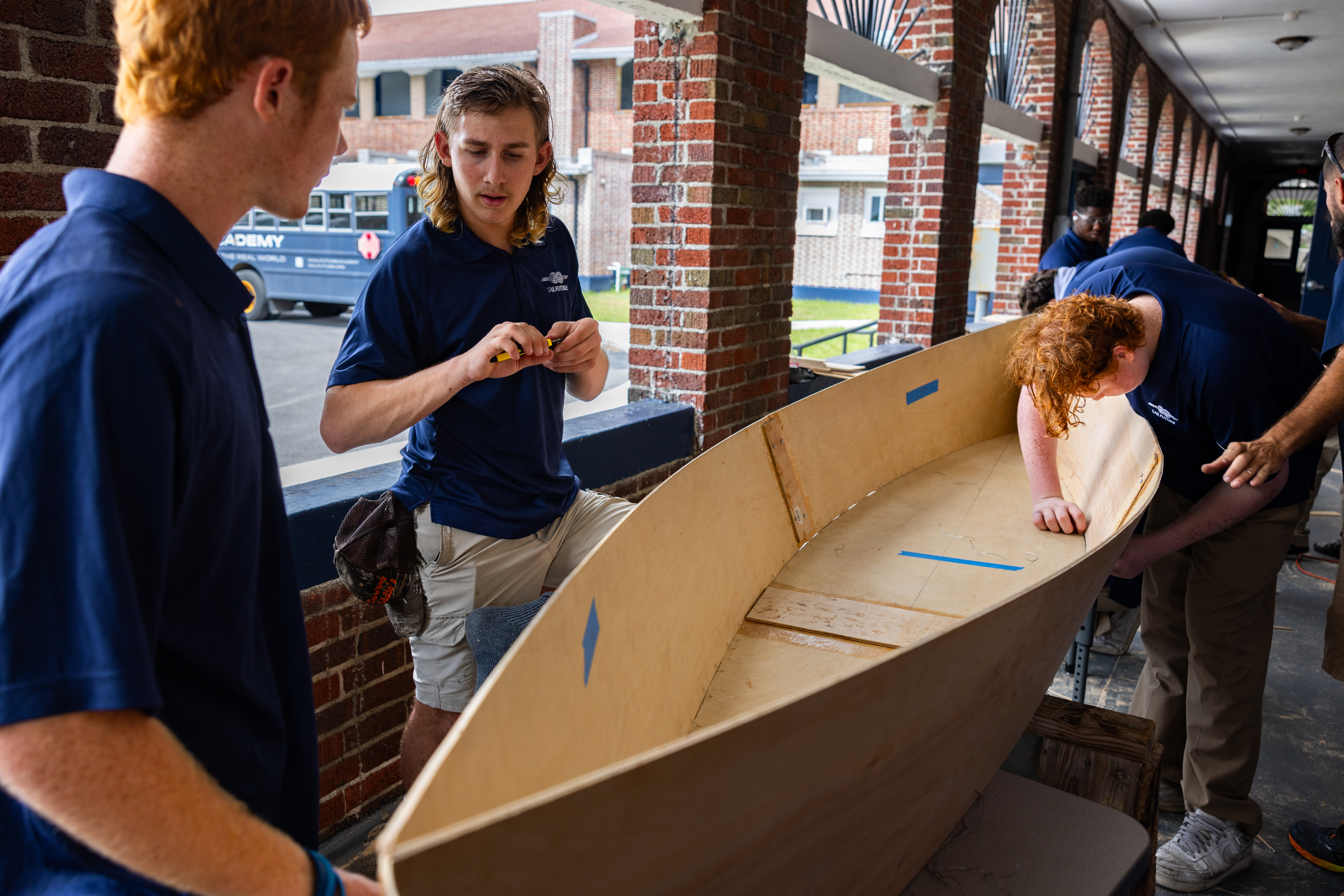 SailFuture Academy students building a wooden canoe