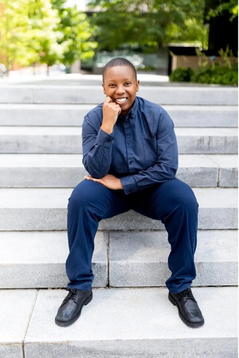 LaShana Lewis sitting on steps outside