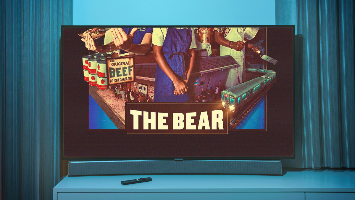 a tv showing a still from the TV show the bear in a blue room