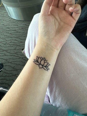 a woman's wrist tattoo with a symbolic meaning of healing