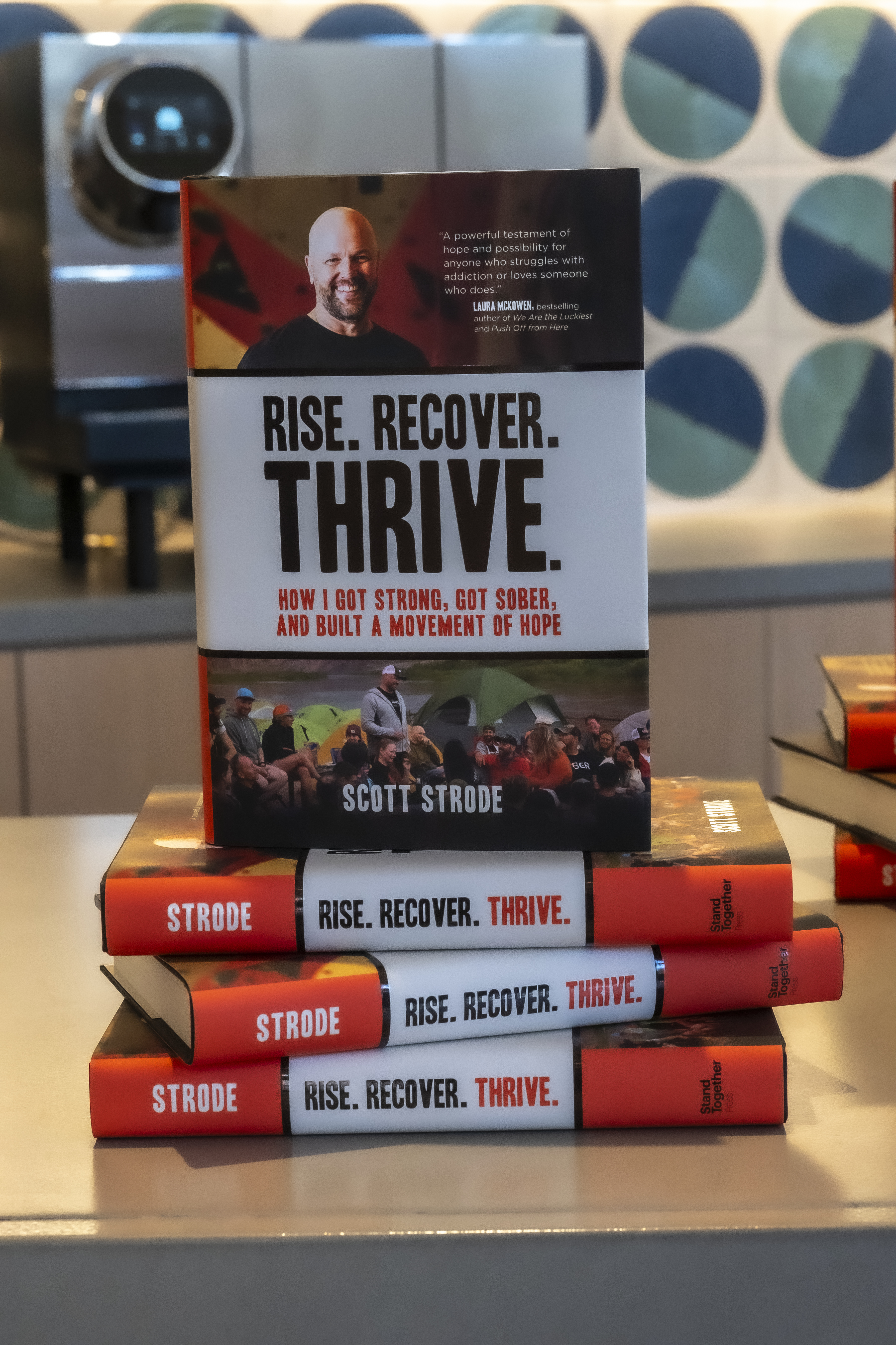 A copy of Scott Strode's book "Rise. Recover. Thrive.: How I Got Strong, Got Sober, and Built a Movement of Hope"