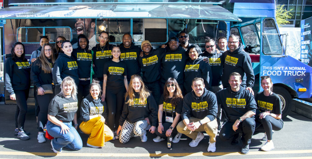 Cafe Momentum ambassadors pose for a photo in front of a food truck