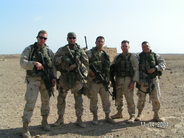John Byrnes poses with fellow soldiers in the Iraq desert