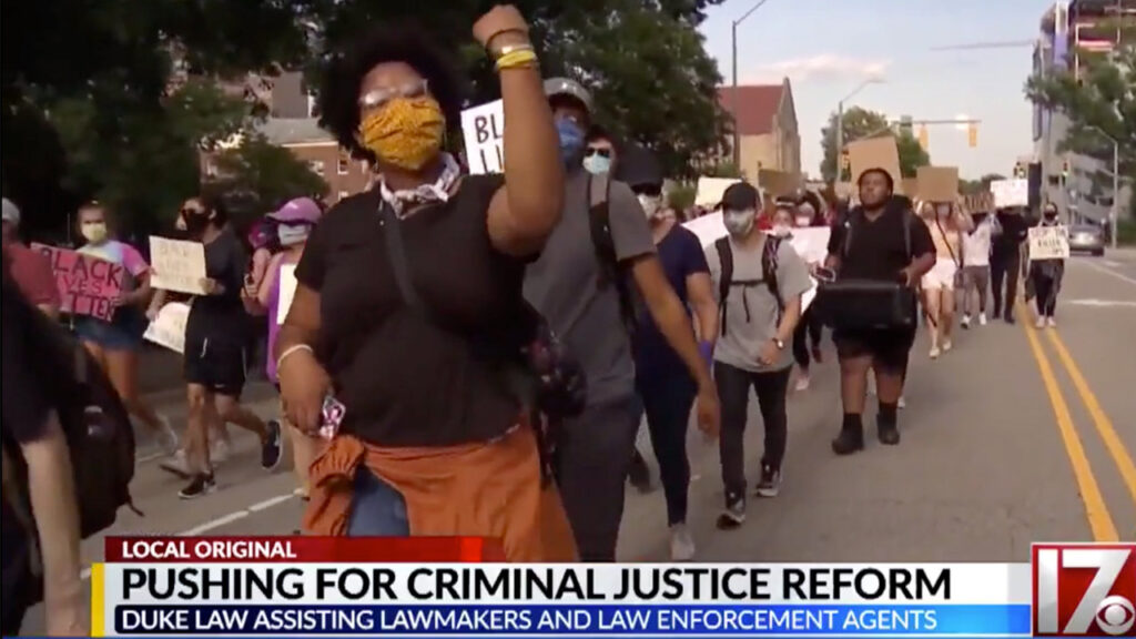 Demonstrators on the news advocating for criminal justice reform