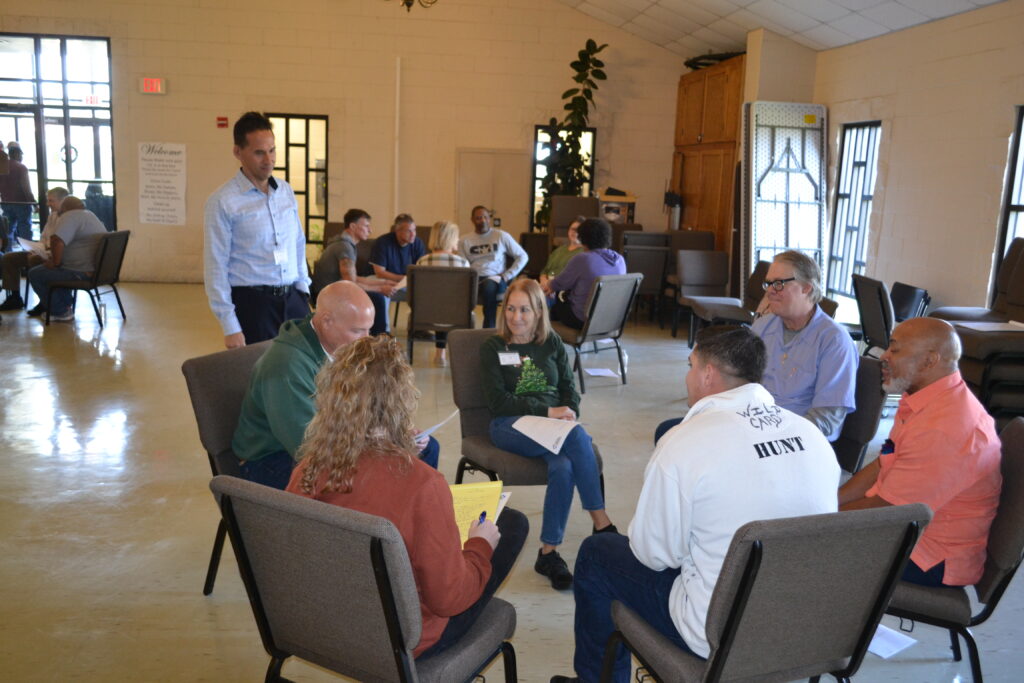 People sitting in circles in small groups