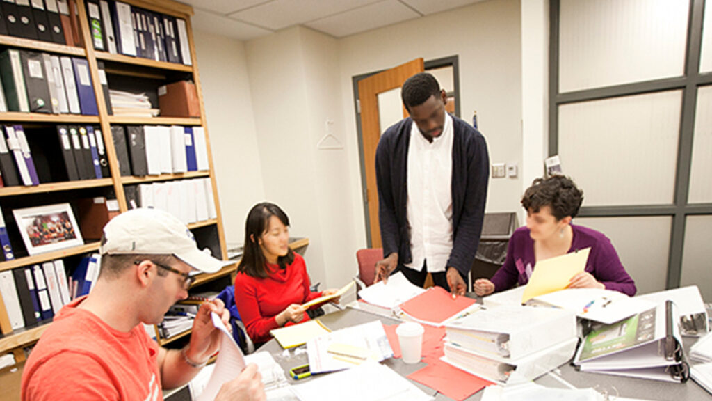 A group of people working at a desk