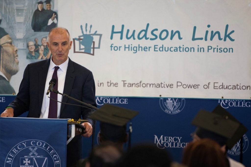 A man speaking at a podium at a Hudson Link event