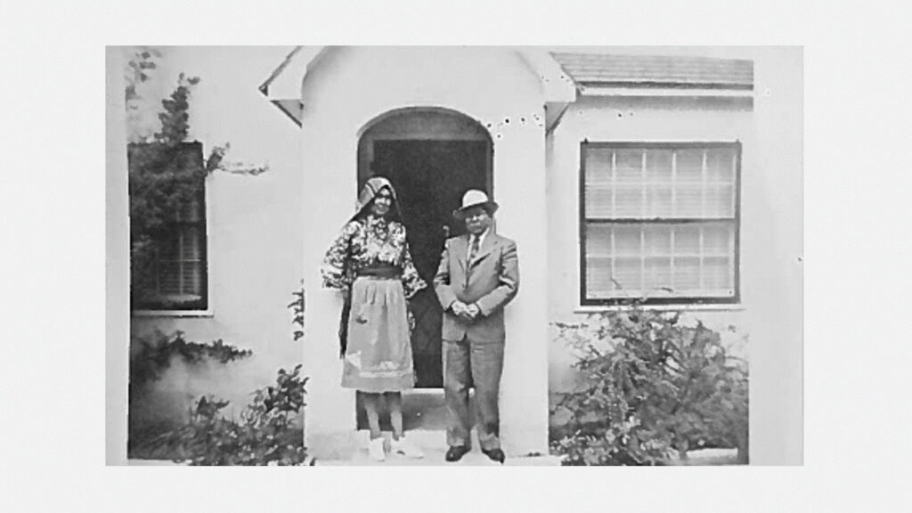 Ron Toya's Grandparents in front of a home