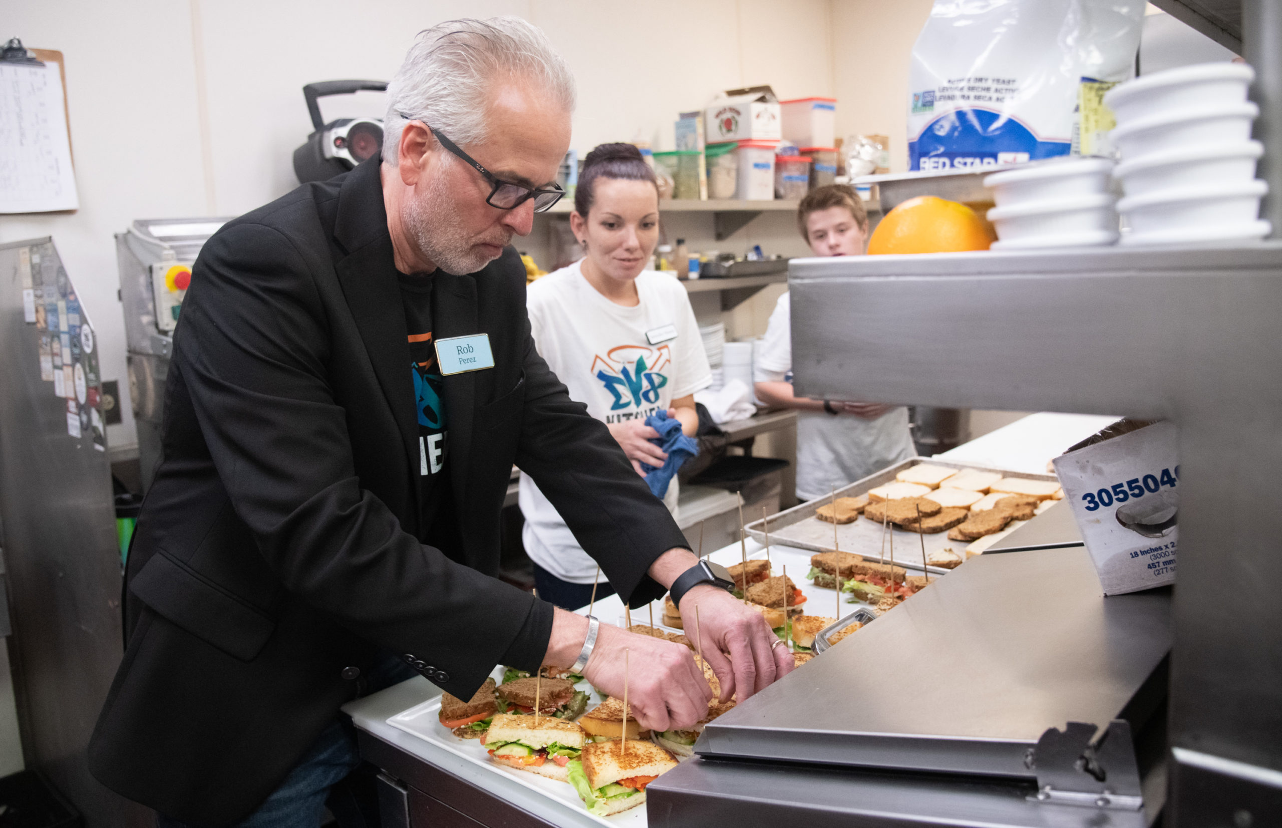 DV8 Kitchen cofounder and co-owner Rob Perez and DV8 senior baker Jennifer prepare sandwiches.