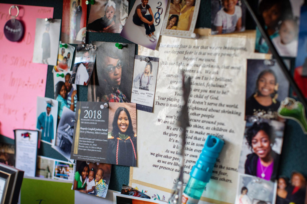A collage of photos and mementos pinned to a wall
