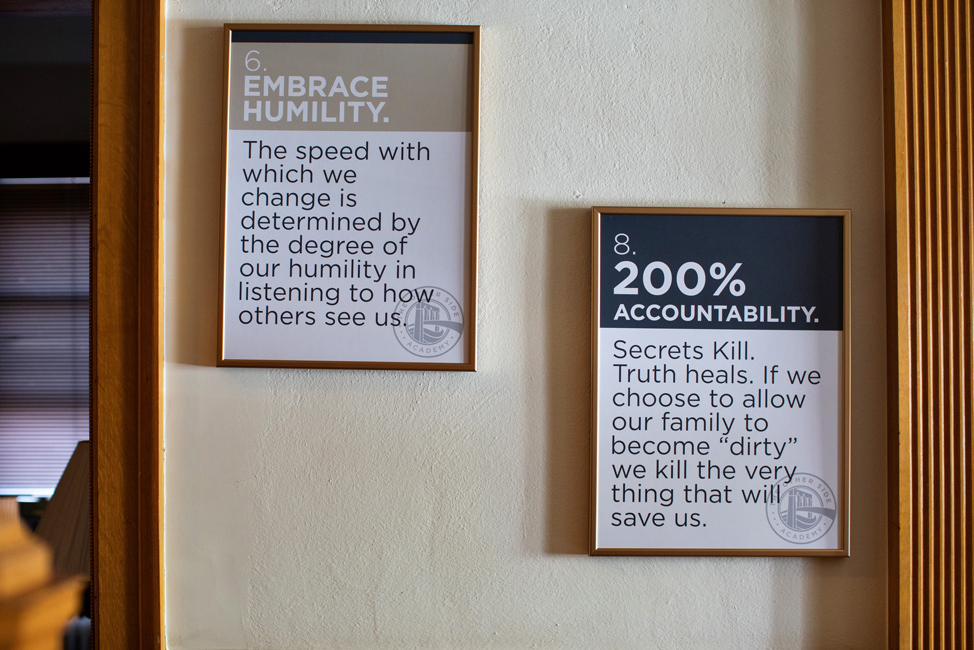 Signs about humility and accountability hung on a wall