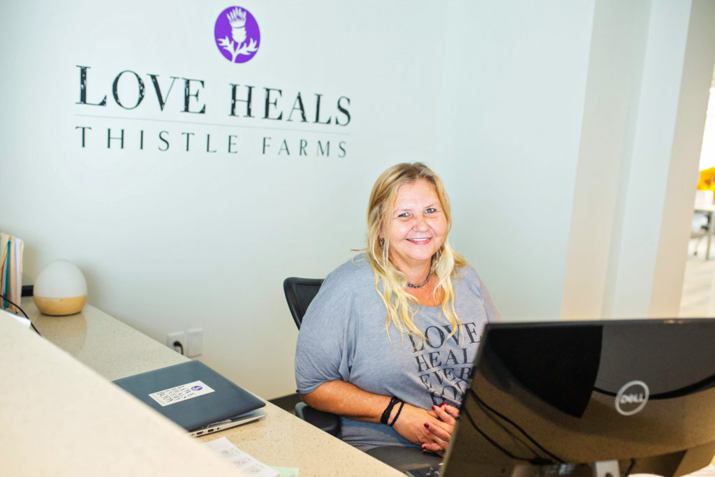 Thistle Farms staff member at the reception desk