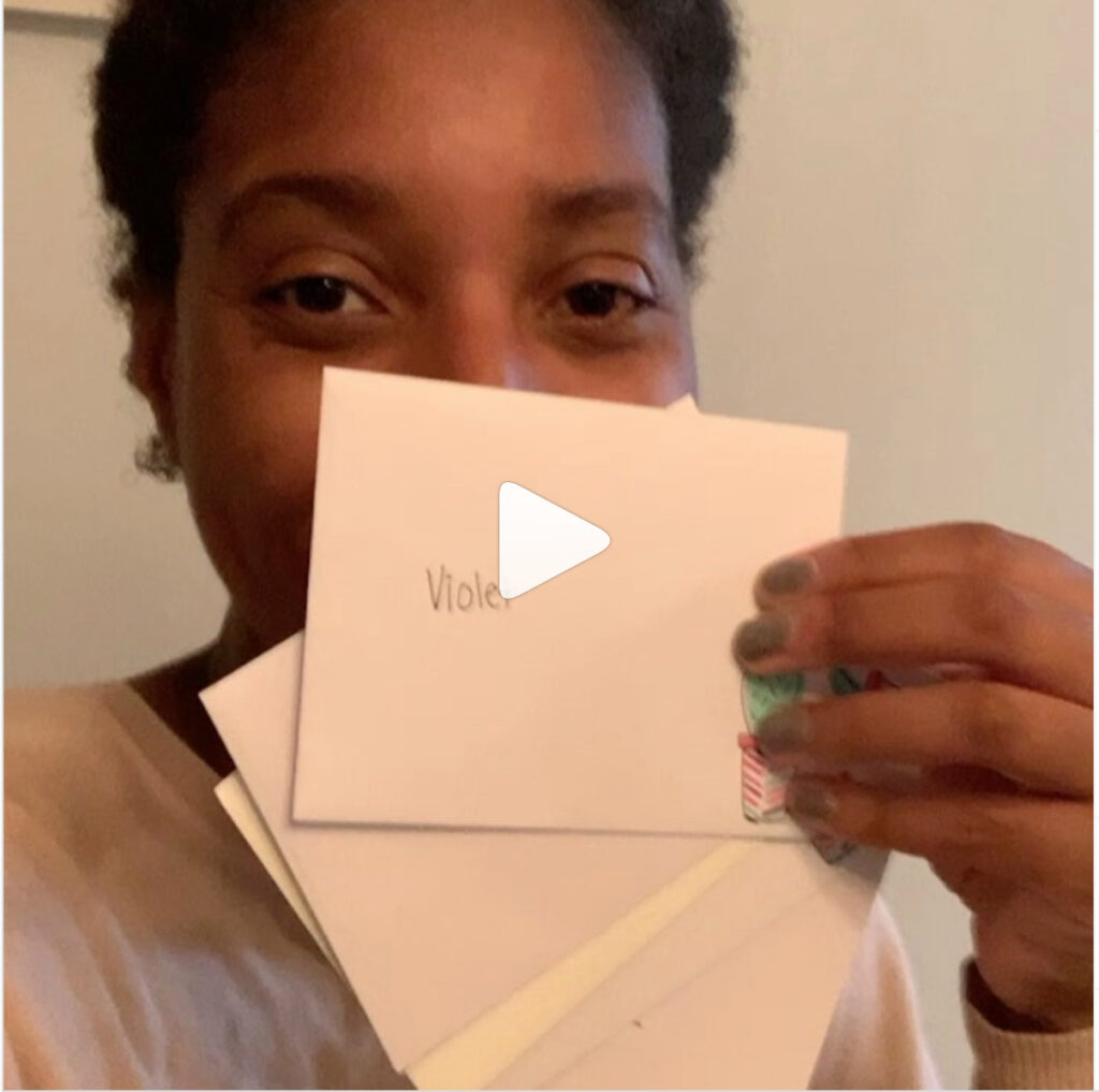 A child holds up notecards