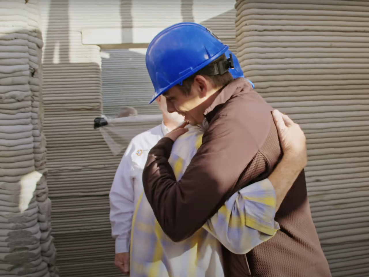 ICON co-founder and CEO Jason Ballard embraces the new resident of a 3D-printed home in Austin, Texas.