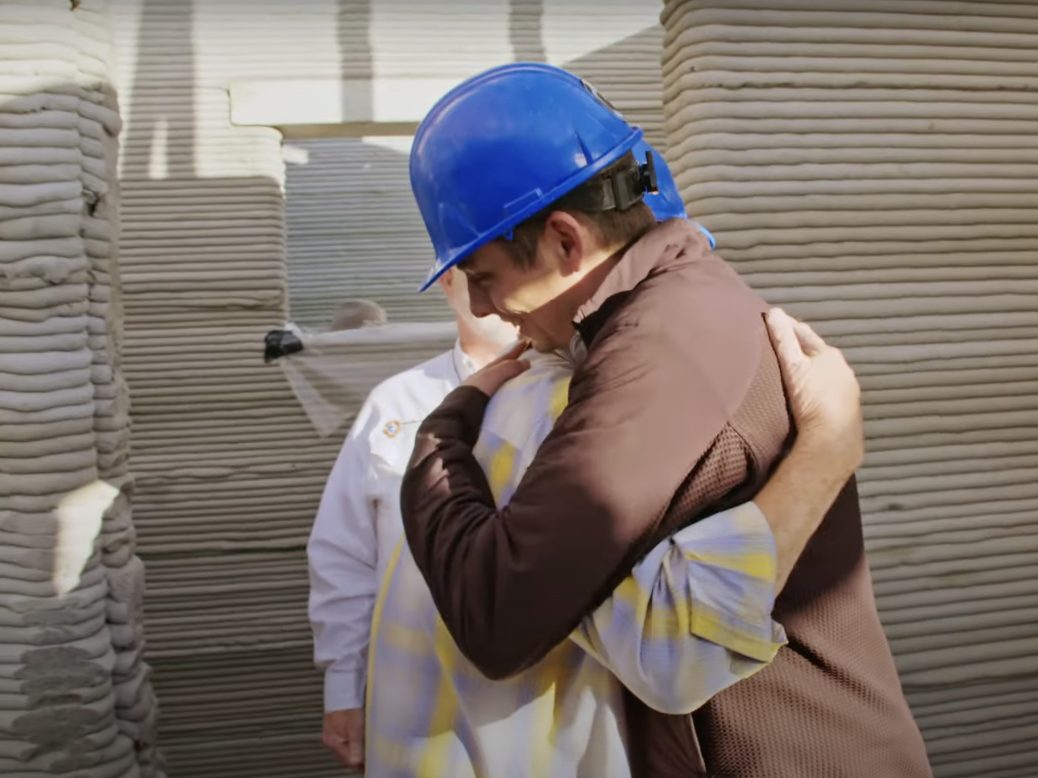 ICON co-founder and CEO Jason Ballard embraces the new resident of a 3D-printed home in Austin, Texas.