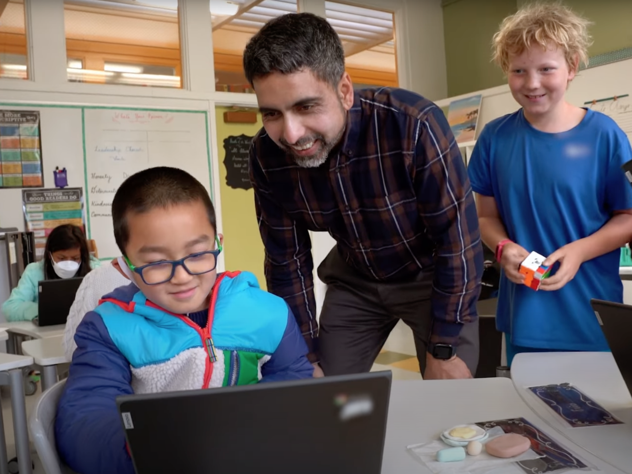 Khan Academy founder Sal Khan engages with children in a classroom.