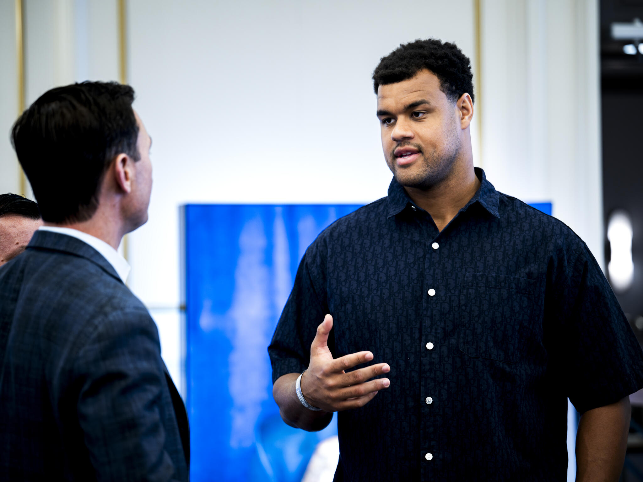 Two men speaking to each other.