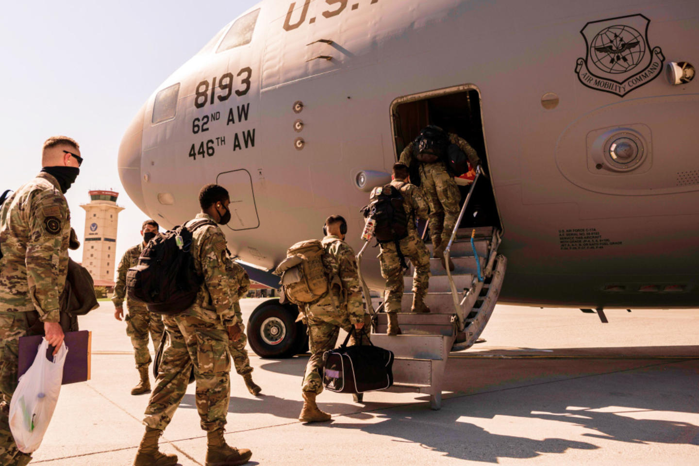 U.S. servicemembers board an airplane.