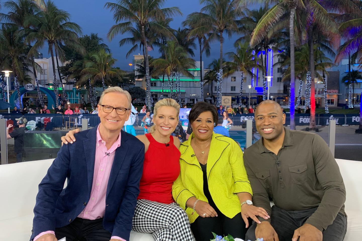 Fox and Friends hosts pose with Alice Marie Johnson on a couch outdoors in Miami