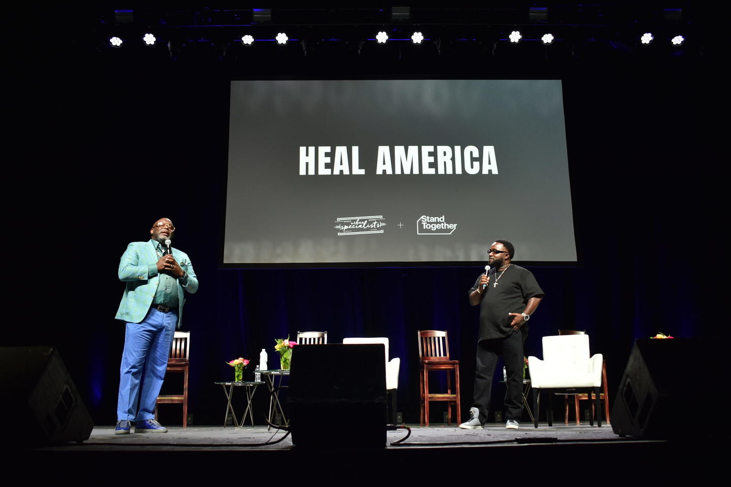 Two speakers on stage at a Heal America event