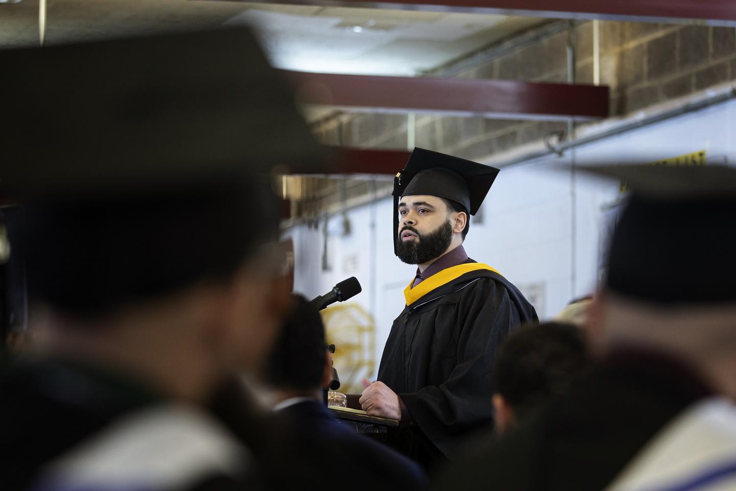 A man giving a speech at a graduation