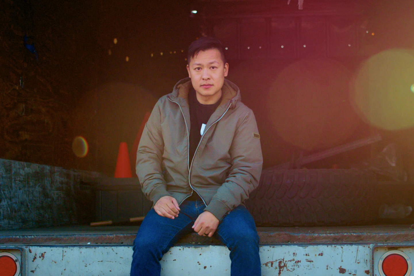 Jason Wang of FreeWorld sitting on a loading dock