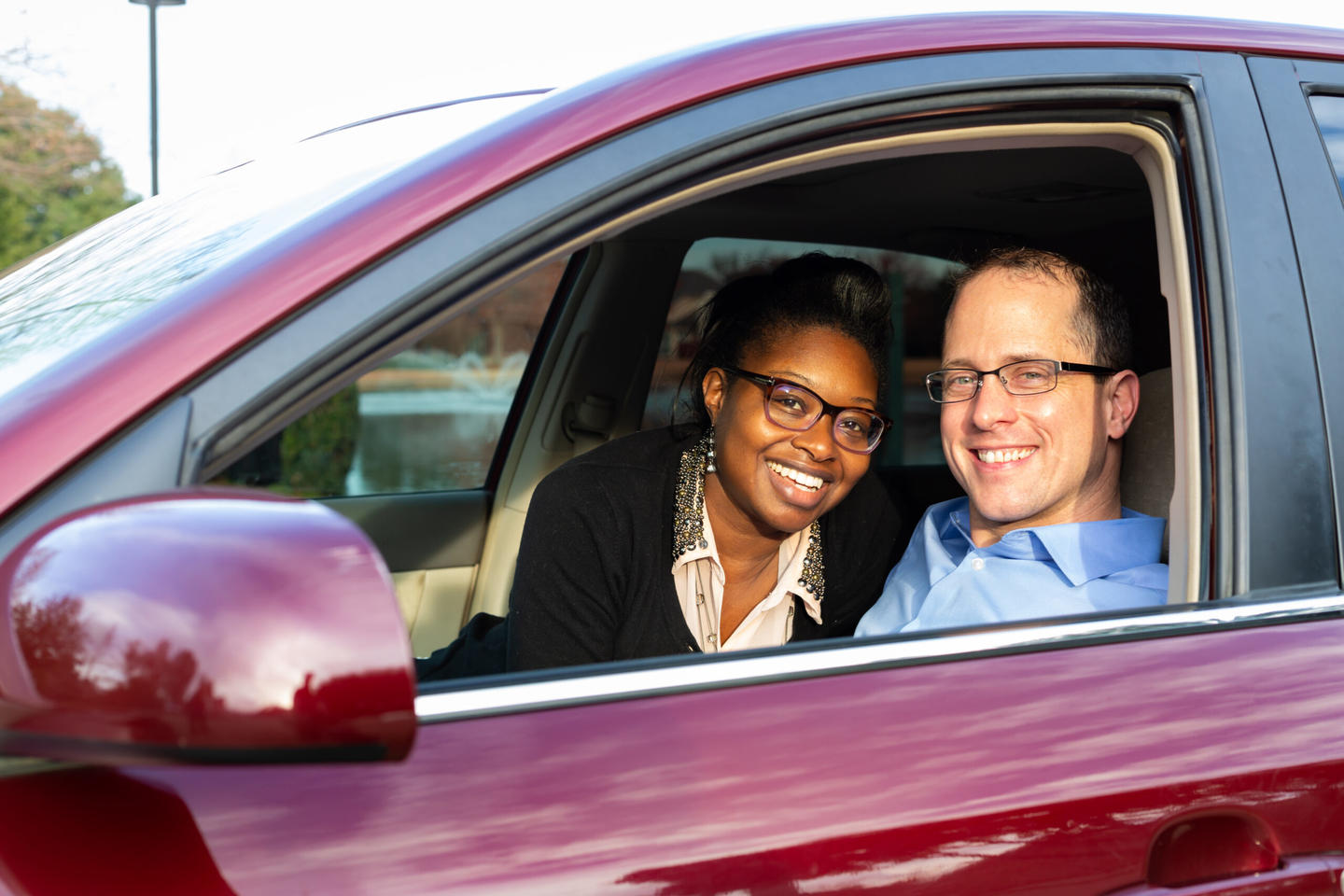 Woman and man in a car smiling
