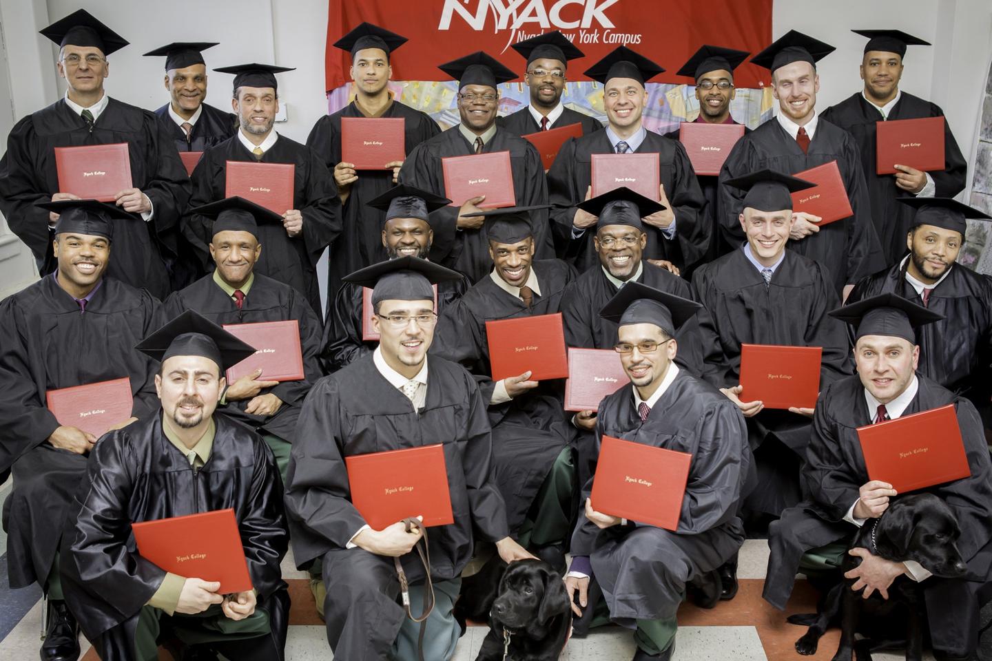 Hudson Link graduates pose for a group photos with their diplomas