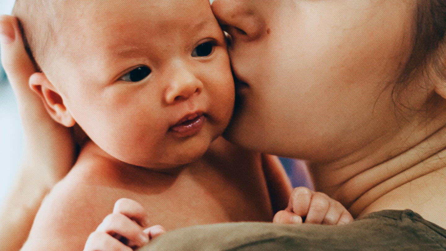 A mother holds her newborn child