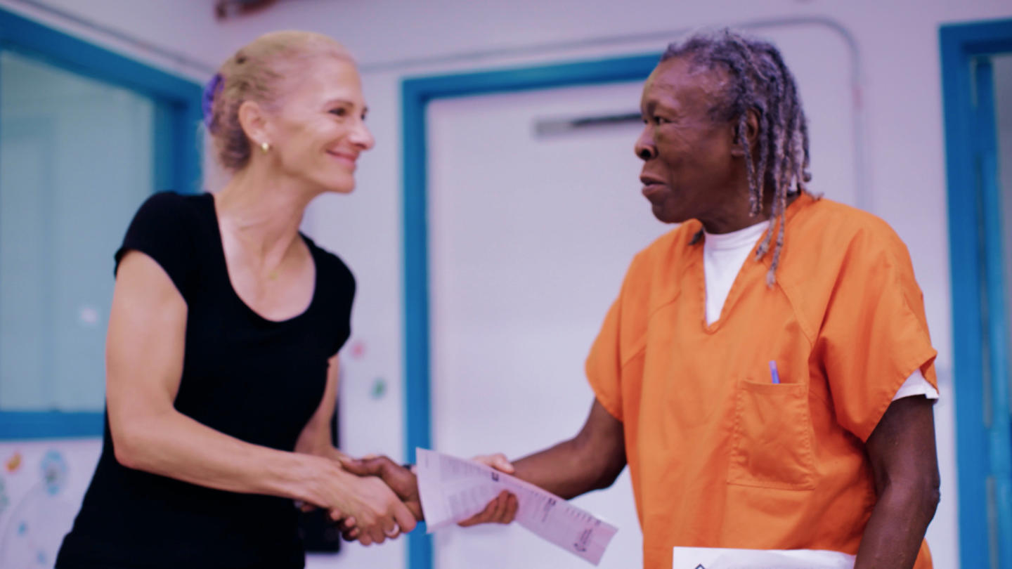 two women shaking hands