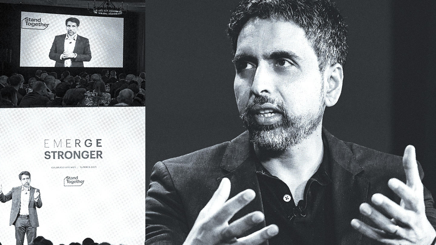 Sal Khan speaking on stage at a conference hosted by Stand Together.