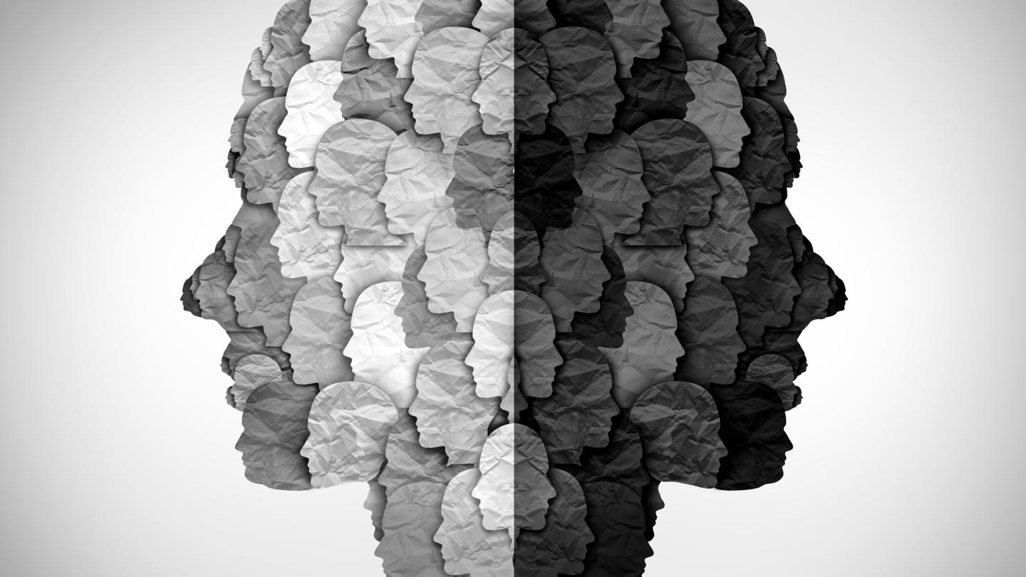 A stock photo of paper faces made up of smaller paper faces