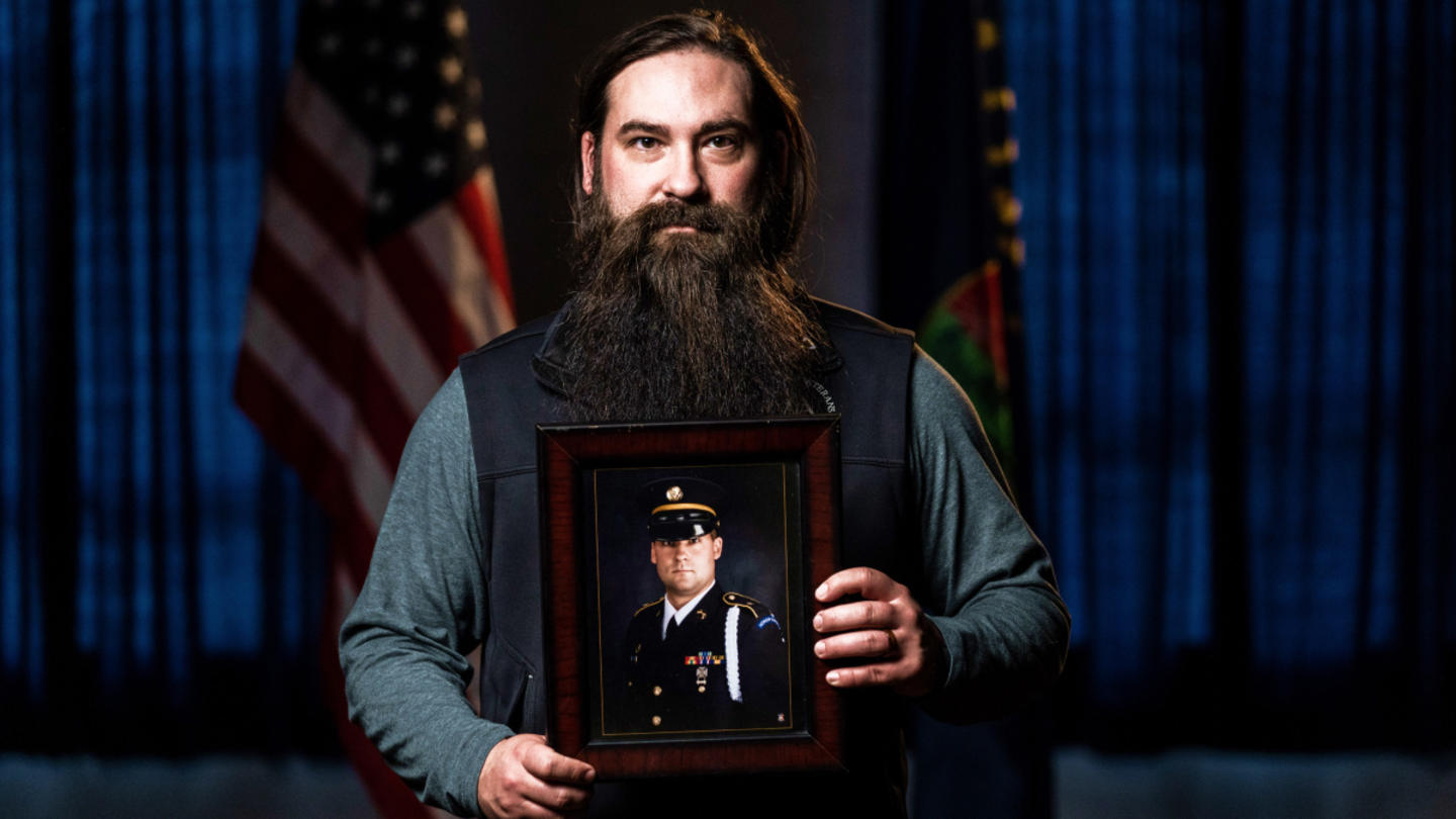 Army veteran Chris Enget holding a photo
