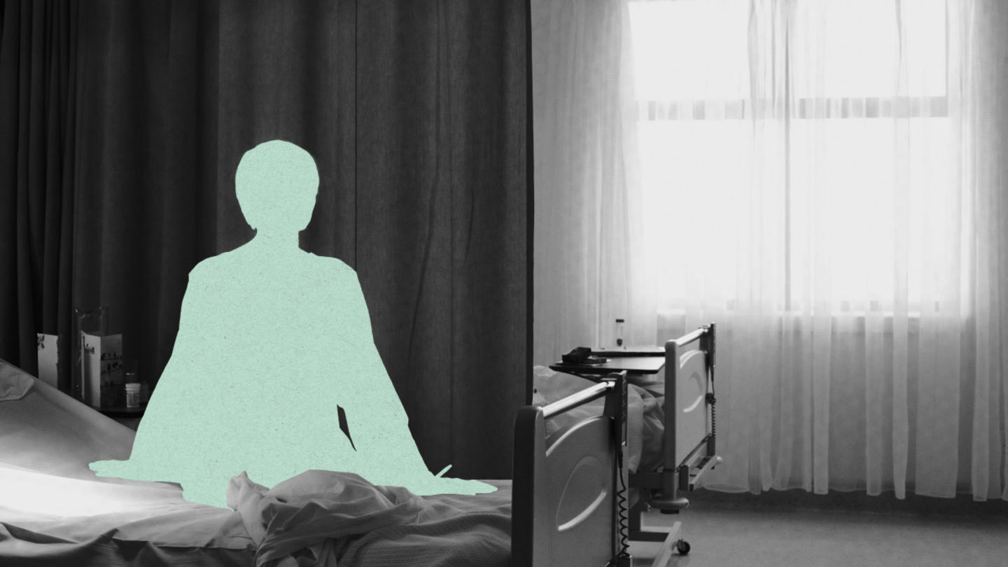 A silhouette of someone with short hair seated on a hospital bed