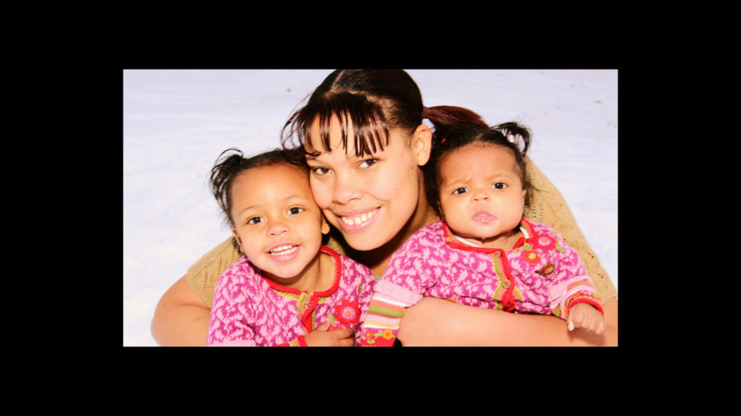 Brittany Williams, a teen mom, hugs her two young children.