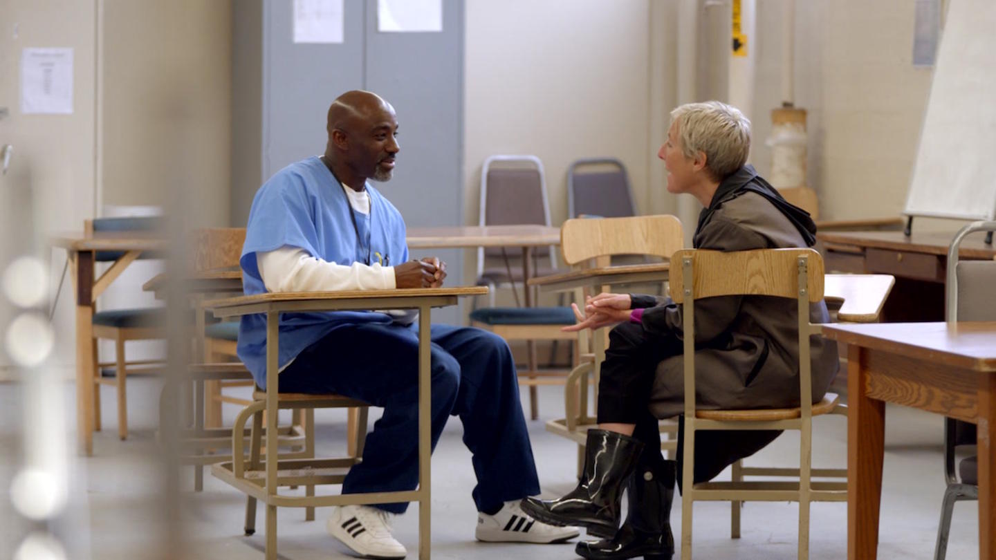 Woman talking to incarcerated man