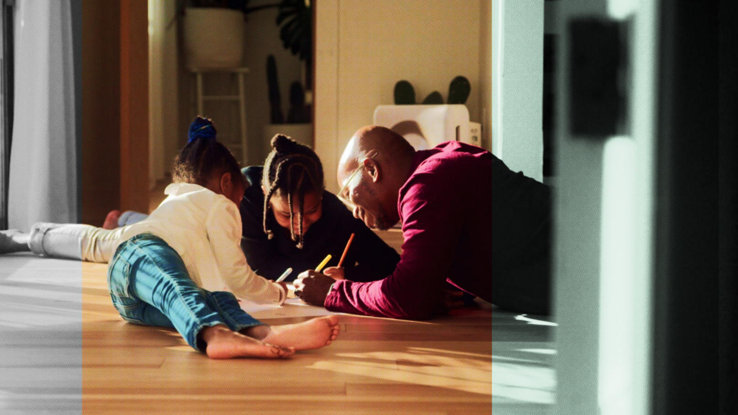 A foster family and child plays together in their house.