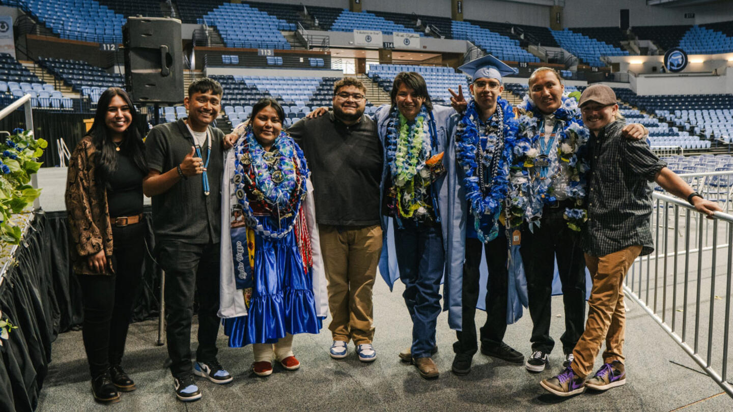 A group of people posing for a photo in an auditorium