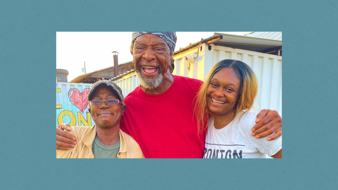 A man and two women hugging