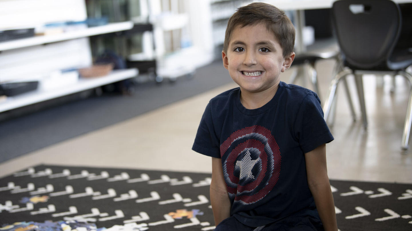 Student who is using student-centered learning smiling