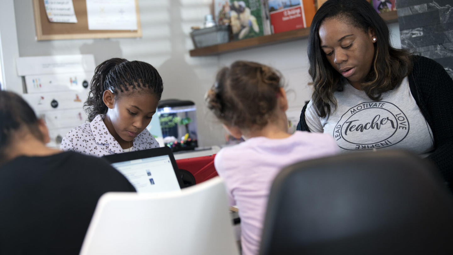 A mother sitting down with her children showing the importance of family engagement in schools