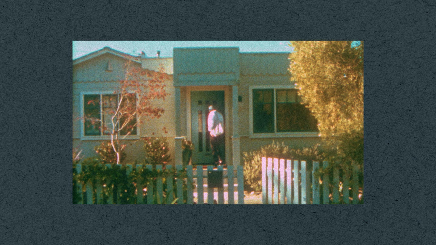 A man standing in front of a house