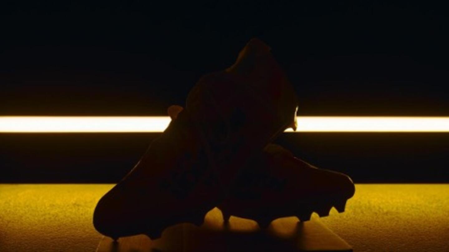 A pair of cleats against dramatic backlighting