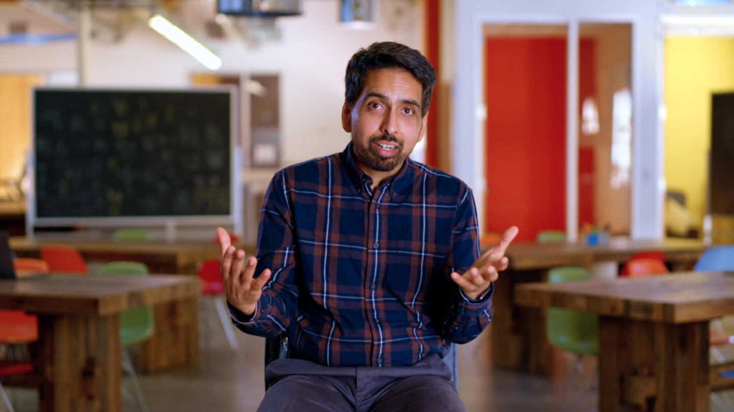 Sal Khan wearing a navy blue checkered button down shirt