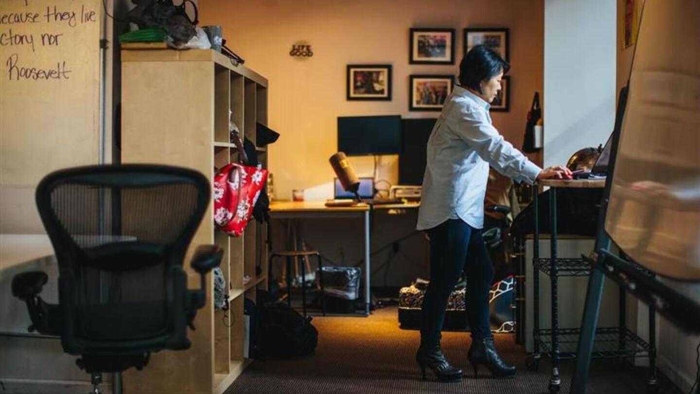 Employee working at a desk in a modern office, a result of skills-based hiring that values capabilities over credentials.