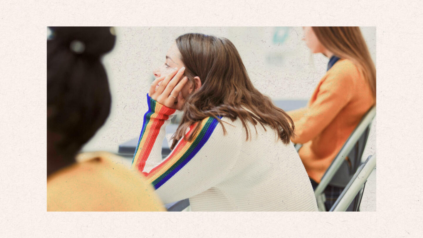 A girl in a classroom focusing on the lesson. 