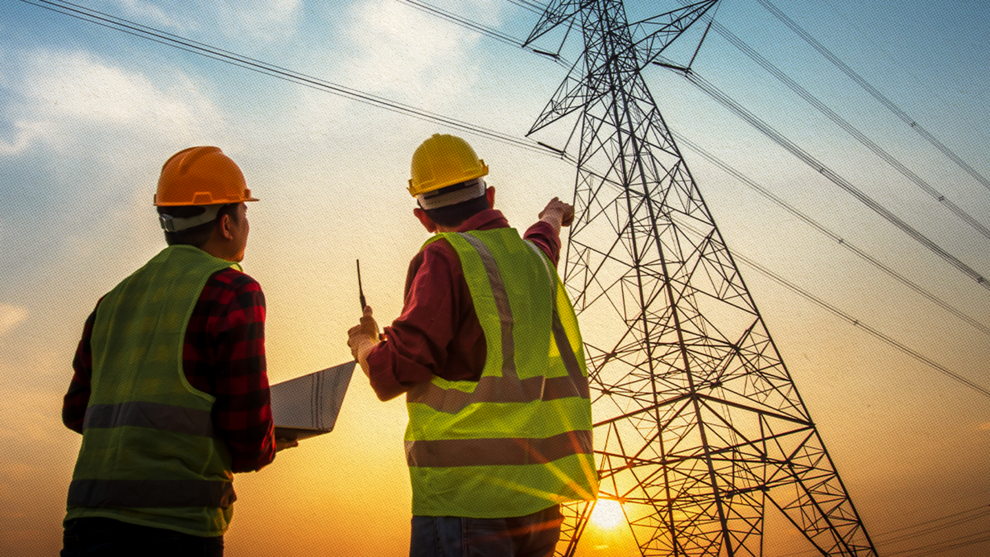 Two energy industry workers pointing at a power line.