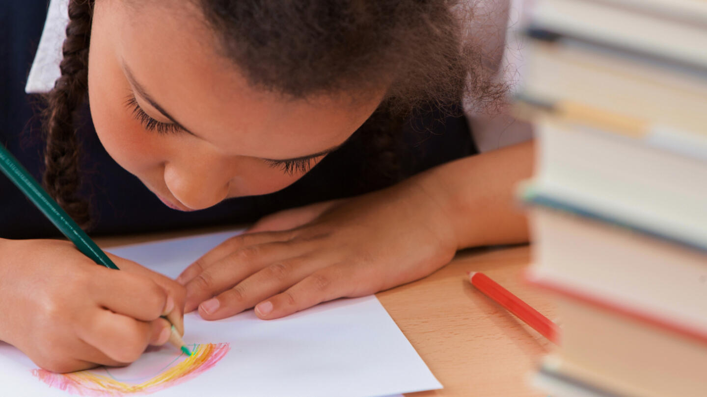 Student drawing with colored pencils.