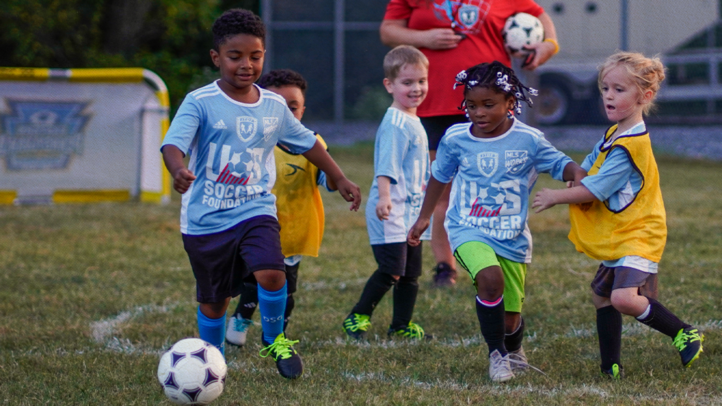 Kids playing soccer.